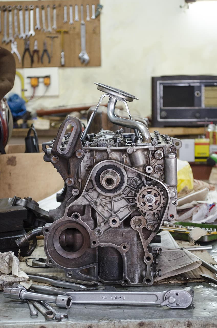 An engine stripped down on a workshop stand